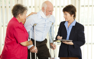 Personal injury attorney interviewing a man on crutches